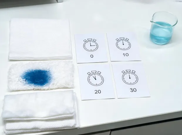 Fluid barrier and absorption test station